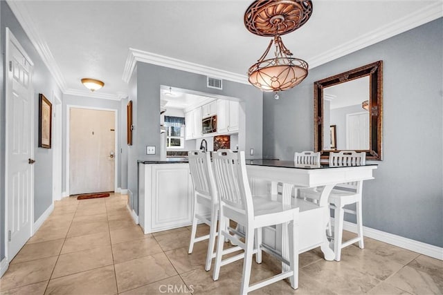 5927 E Creekside Ave Unit 18, Orange, CA 92869 - dining area featuring crown molding, baseboards, and light tile patterned floors