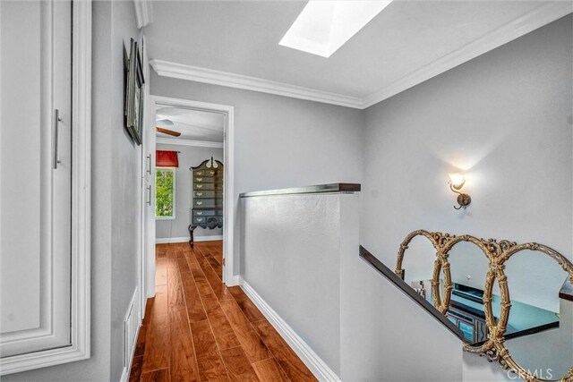 5927 E Creekside Ave Unit 18, Orange, CA 92869 - hall featuring an upstairs landing, a skylight, crown molding, wood finished floors, and baseboards