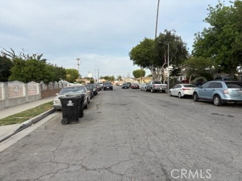 1413 E 77th St, Los Angeles, CA 90001 - view of asphalt street featuring street lights and sidewalks