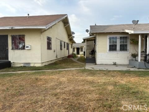 1413 E 77th St, Los Angeles, CA 90001 - back of property with a lawn