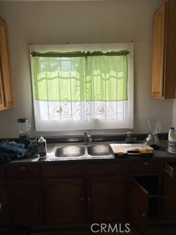 1413 E 77th St, Los Angeles, CA 90001 - kitchen featuring a sink and dark countertops