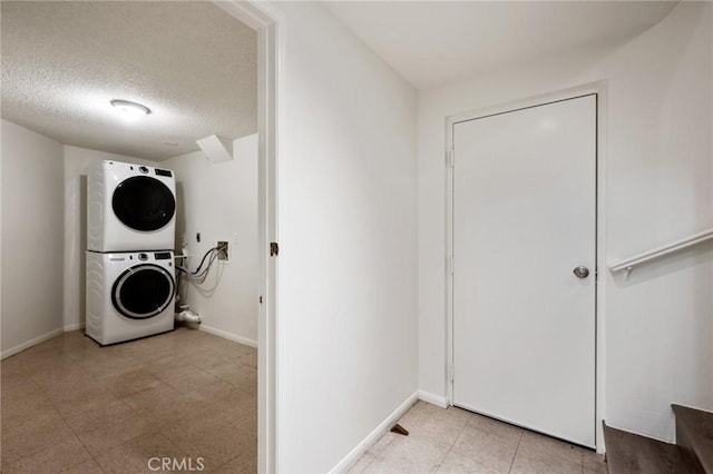 2601 E 19th St Unit 30, Signal Hill, CA 90755 - washroom with stacked washer and clothes dryer, a textured ceiling, and baseboards