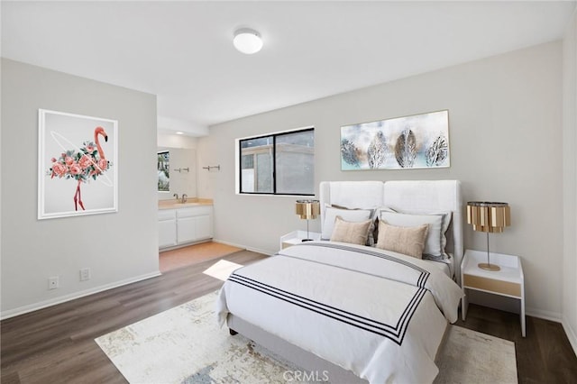 2601 E 19th St Unit 30, Signal Hill, CA 90755 - bedroom with wood finished floors, baseboards, connected bathroom, and a sink