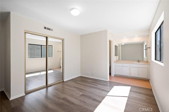 2601 E 19th St Unit 30, Signal Hill, CA 90755 - unfurnished bedroom featuring wood finished floors, a sink, and baseboards