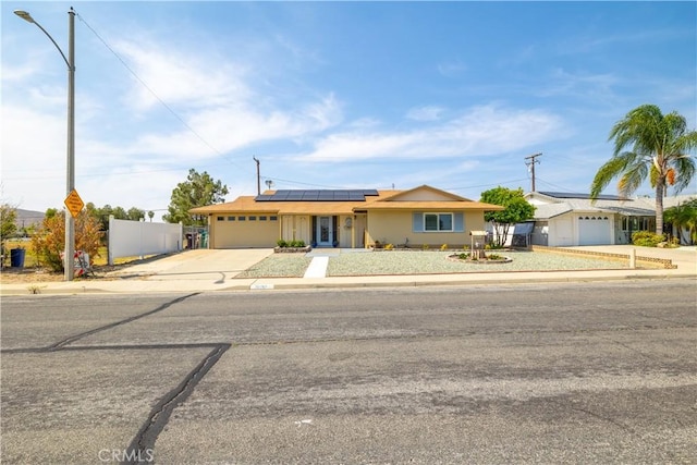 26190 Ridgemoor Rd, Menifee, CA 92586 - single story home with an attached garage, concrete driveway, and roof mounted solar panels