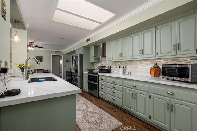 26190 Ridgemoor Rd, Menifee, CA 92586 - kitchen with stainless steel appliances, wall chimney range hood, green cabinetry, a sink, and ornamental molding