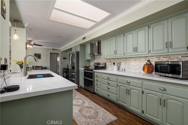 26190 Ridgemoor Rd, Menifee, CA 92586 - kitchen featuring stainless steel appliances, wall chimney exhaust hood, green cabinets, ornamental molding, and backsplash