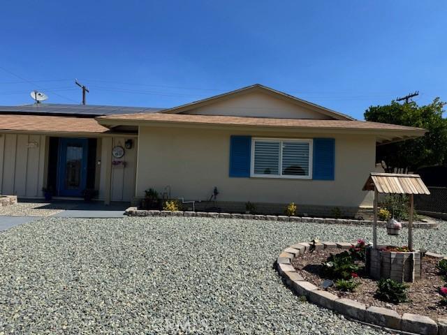 26190 Ridgemoor Rd, Menifee, CA 92586 - ranch-style home featuring roof mounted solar panels and stucco siding