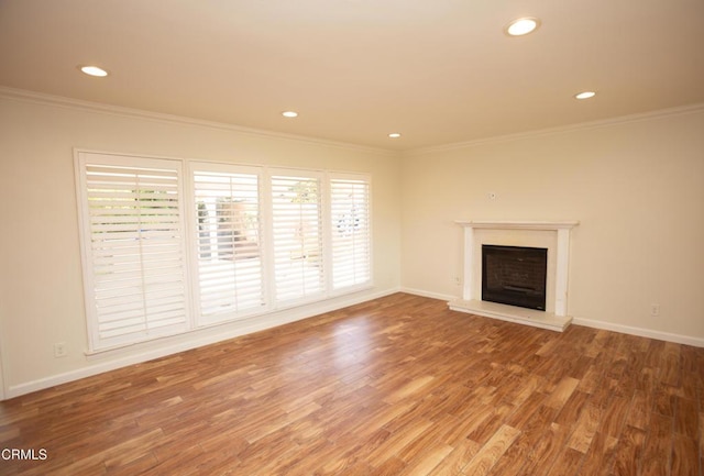 1207 S L St, Oxnard, CA 93033 - unfurnished living room featuring ornamental molding, recessed lighting, light wood-style flooring, and a fireplace with raised hearth