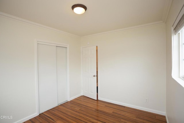 1207 S L St, Oxnard, CA 93033 - unfurnished bedroom with dark wood-type flooring, ornamental molding, and a closet