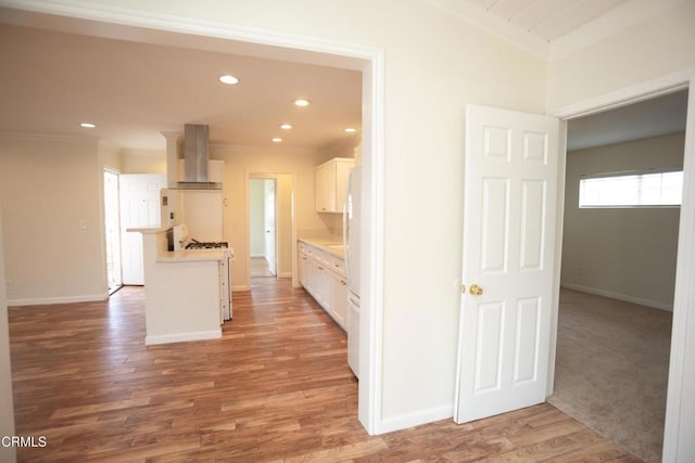 1207 S L St, Oxnard, CA 93033 - kitchen with wall chimney exhaust hood, ornamental molding, white appliances, white cabinets, and light countertops