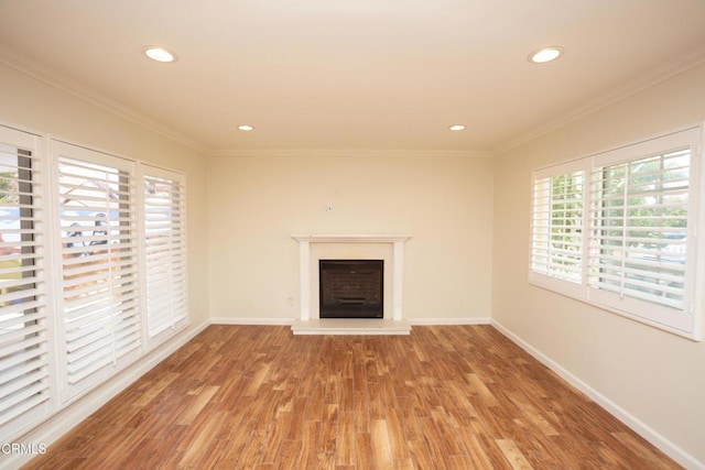 1207 S L St, Oxnard, CA 93033 - unfurnished living room with a fireplace with raised hearth, wood finished floors, recessed lighting, and ornamental molding