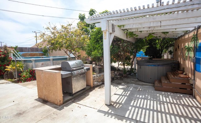 1207 S L St, Oxnard, CA 93033 - fenced backyard featuring a hot tub, a patio area, and an outdoor kitchen