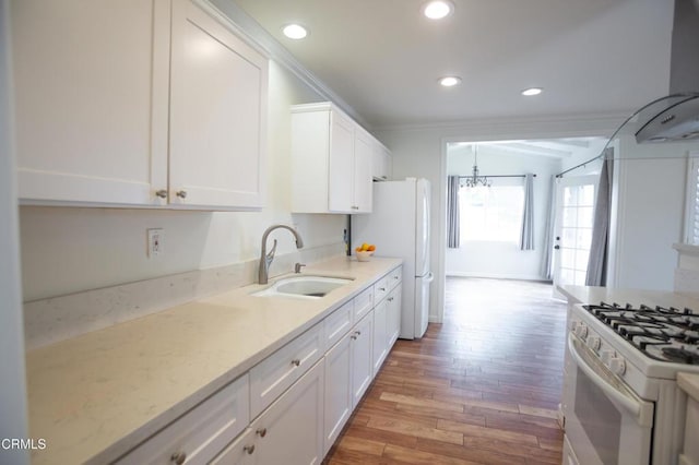 1207 S L St, Oxnard, CA 93033 - kitchen with light wood-style flooring, white appliances, white cabinets, ventilation hood, and recessed lighting