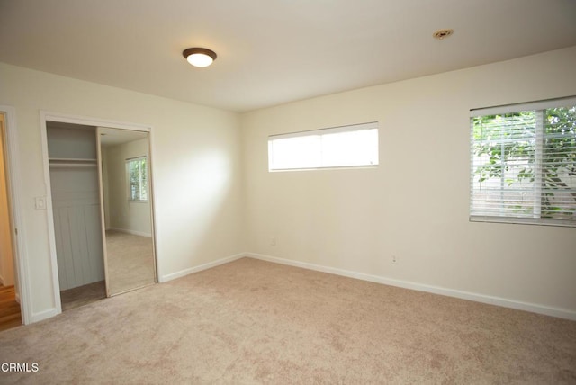 1207 S L St, Oxnard, CA 93033 - unfurnished bedroom with carpet, multiple windows, and a closet