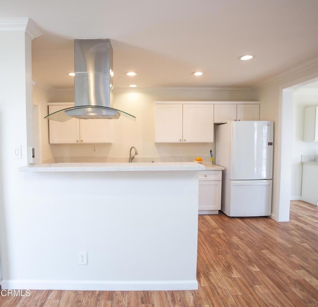1207 S L St, Oxnard, CA 93033 - kitchen featuring freestanding refrigerator, island range hood, crown molding, white cabinets, and light wood-style floors