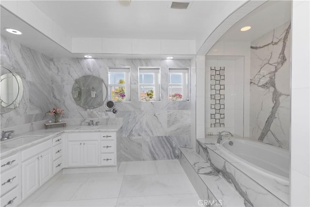 8851 Soothing Ct, Corona, CA 92883 - bathroom featuring a bath, double vanity, marble finish flooring, tile walls, and recessed lighting