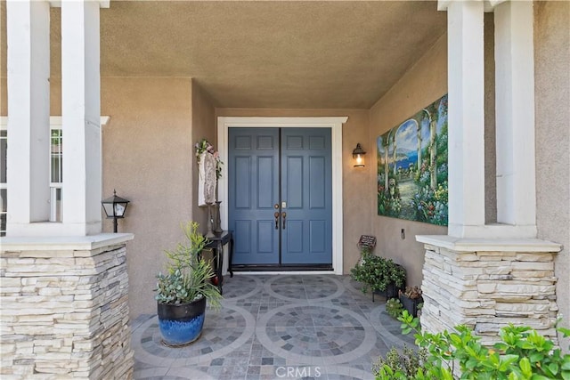 8851 Soothing Ct, Corona, CA 92883 - doorway to property with stucco siding and stone siding