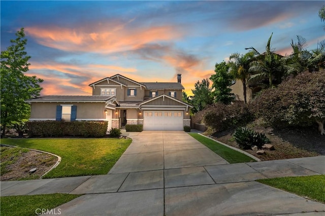 8851 Soothing Ct, Corona, CA 92883 - view of front facade featuring concrete driveway, stone siding, stucco siding, a yard, and a chimney
