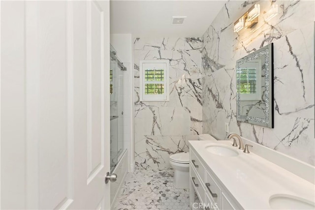 8851 Soothing Ct, Corona, CA 92883 - full bathroom with plenty of natural light, double vanity, toilet, shower / bath combination with glass door, and tile walls