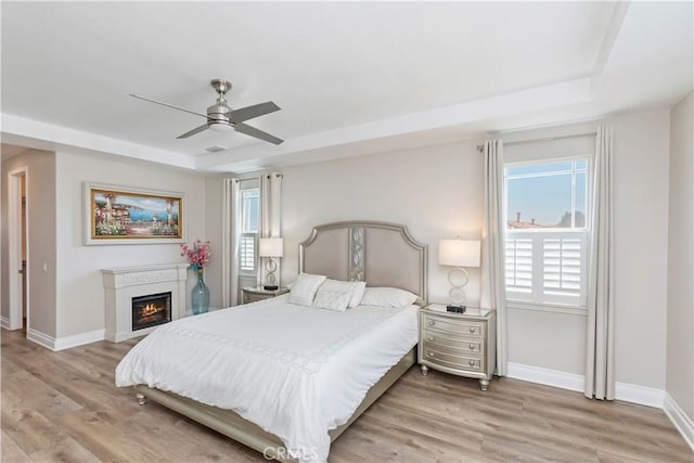 8851 Soothing Ct, Corona, CA 92883 - bedroom with baseboards, a raised ceiling, and light wood-type flooring