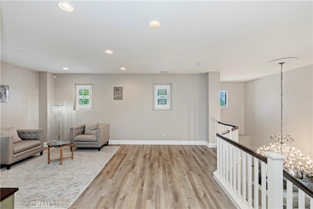 8851 Soothing Ct, Corona, CA 92883 - sitting room featuring an upstairs landing, a chandelier, light wood-style flooring, recessed lighting, and baseboards