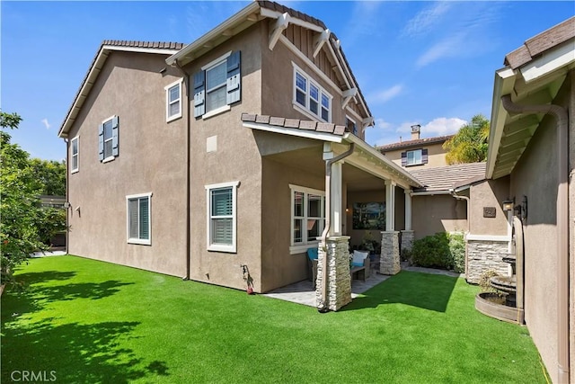 8851 Soothing Ct, Corona, CA 92883 - back of house with stucco siding, a patio area, and a lawn