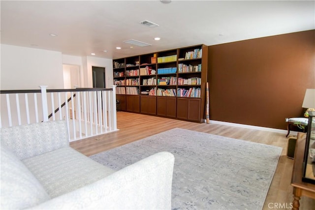 24649 Round Meadow Dr, Menifee, CA 92584 - sitting room featuring wood finished floors, an upstairs landing, baseboards, and recessed lighting