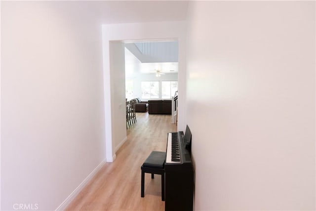 24649 Round Meadow Dr, Menifee, CA 92584 - corridor featuring light wood-style floors and baseboards