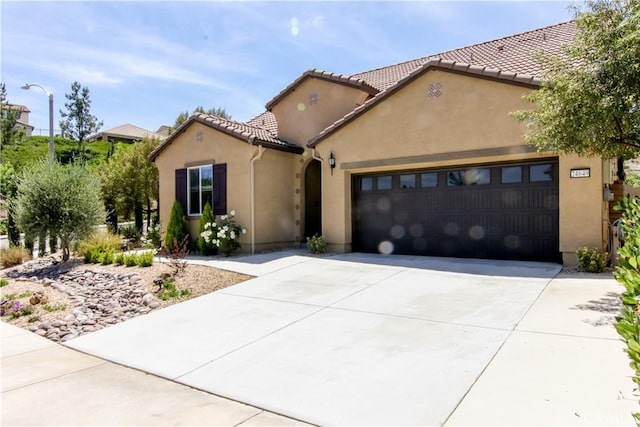 24649 Round Meadow Dr, Menifee, CA 92584 - mediterranean / spanish house with stucco siding, an attached garage, concrete driveway, and a tiled roof