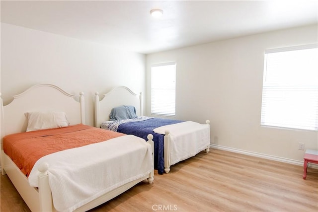 24649 Round Meadow Dr, Menifee, CA 92584 - bedroom with light wood-style floors and baseboards