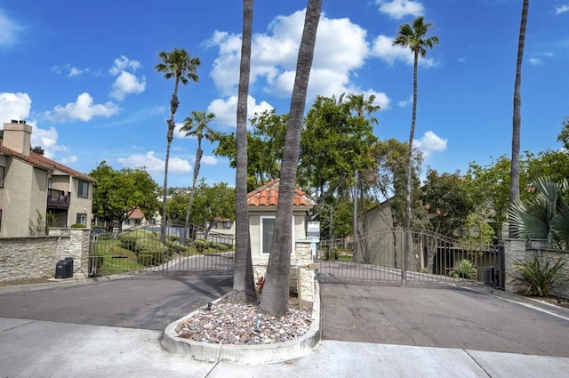 7753 Caminito Encanto Unit 102, Carlsbad, CA 92009 - view of asphalt street featuring a gate, curbs, and a gated entry