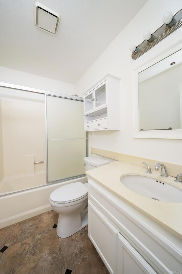 7753 Caminito Encanto Unit 102, Carlsbad, CA 92009 - full bath featuring vanity, toilet, shower / bath combination with glass door, and stone finish flooring