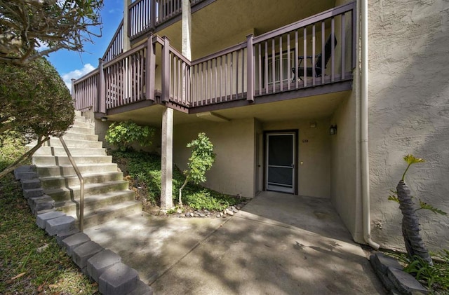 7753 Caminito Encanto Unit 102, Carlsbad, CA 92009 - doorway to property featuring stucco siding and a patio area