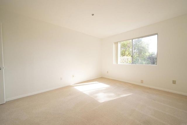 7753 Caminito Encanto Unit 102, Carlsbad, CA 92009 - spare room featuring light carpet and baseboards