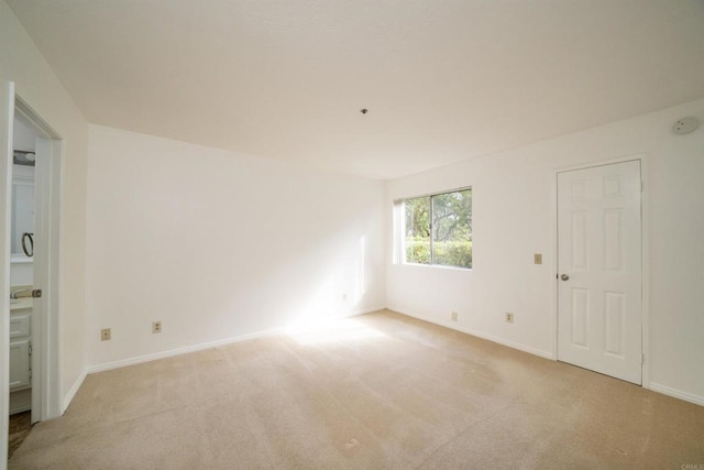 7753 Caminito Encanto Unit 102, Carlsbad, CA 92009 - spare room with light colored carpet, baseboards, and a smoke detector
