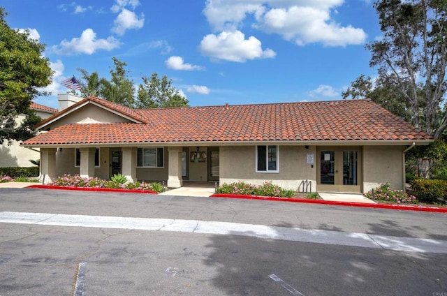 7753 Caminito Encanto Unit 102, Carlsbad, CA 92009 - view of front of property with french doors, stucco siding, and a tiled roof