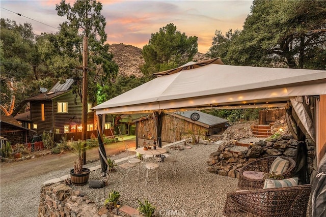 31342 Silverado Canyon Rd, Silverado Canyon, CA 92676 - yard at dusk with a gazebo and a patio area