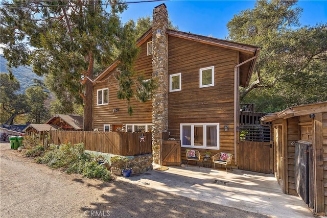 31342 Silverado Canyon Rd, Silverado Canyon, CA 92676 - view of side of home with a gate and a chimney