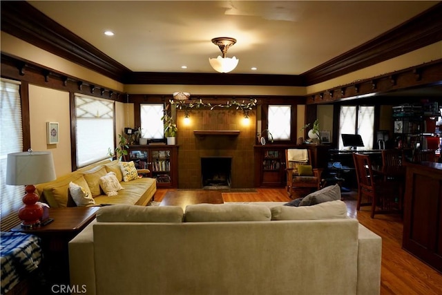 163 S Kingsley, Los Angeles, CA 90004 - living area with crown molding, plenty of natural light, a fireplace, wood finished floors, and recessed lighting