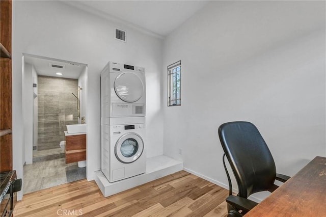 163 S Kingsley, Los Angeles, CA 90004 - laundry room featuring stacked washer / drying machine, wood finished floors, an office area, and baseboards