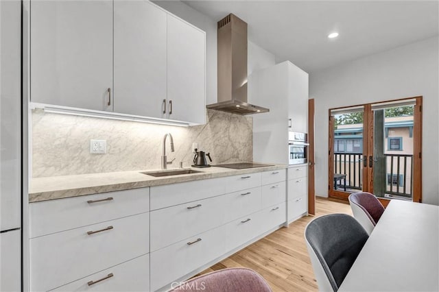 163 S Kingsley, Los Angeles, CA 90004 - kitchen featuring wall chimney exhaust hood, a sink, light wood-style flooring, decorative backsplash, and oven