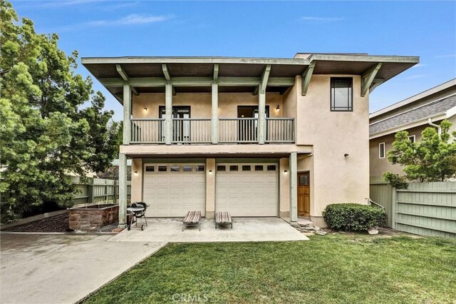 163 S Kingsley, Los Angeles, CA 90004 - back of property featuring a balcony, stucco siding, an attached garage, and concrete driveway