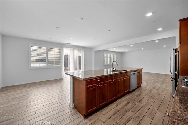 6864 Ripple Ct, Jurupa Valley, CA 91752 - kitchen featuring open floor plan, a sink, light wood-style flooring, stainless steel appliances, and dark brown cabinets