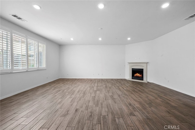 6864 Ripple Ct, Jurupa Valley, CA 91752 - unfurnished living room featuring wood finished floors, recessed lighting, a warm lit fireplace, and baseboards