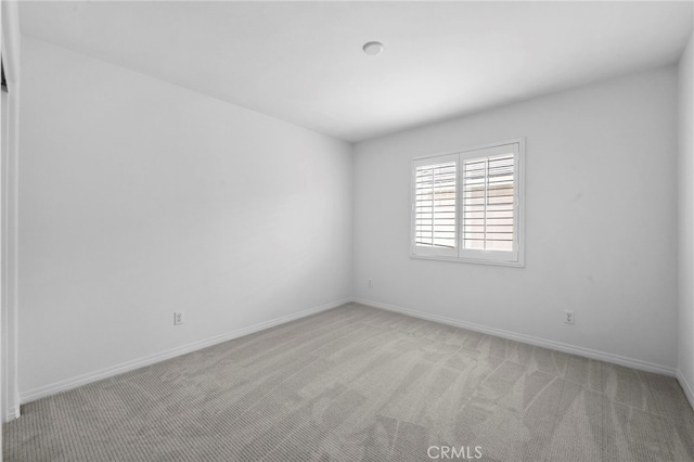 6864 Ripple Ct, Jurupa Valley, CA 91752 - empty room with light carpet and baseboards