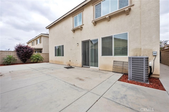 6864 Ripple Ct, Jurupa Valley, CA 91752 - rear view of property with cooling unit, stucco siding, a fenced backyard, and a patio area