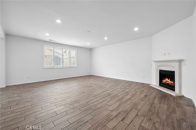 6864 Ripple Ct, Jurupa Valley, CA 91752 - unfurnished living room with wood finished floors, a warm lit fireplace, recessed lighting, and baseboards