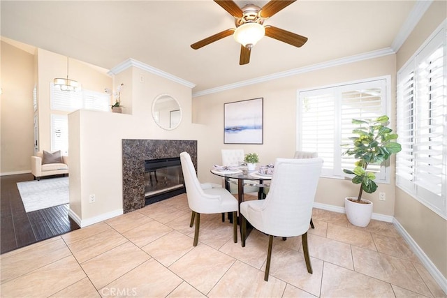 11015 Charleston St, Rancho Cucamonga, CA 91701 - dining area featuring healthy amount of natural light, crown molding, a premium fireplace, and a ceiling fan