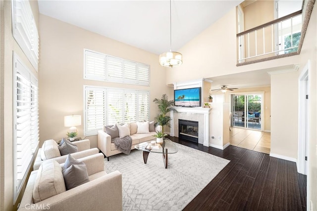 11015 Charleston St, Rancho Cucamonga, CA 91701 - living area with a glass covered fireplace, a towering ceiling, baseboards, dark wood finished floors, and a ceiling fan